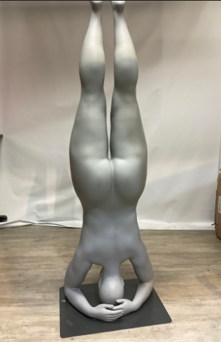 Used plus size mannequin in yoga pose