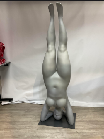 Used plus size mannequin in yoga pose